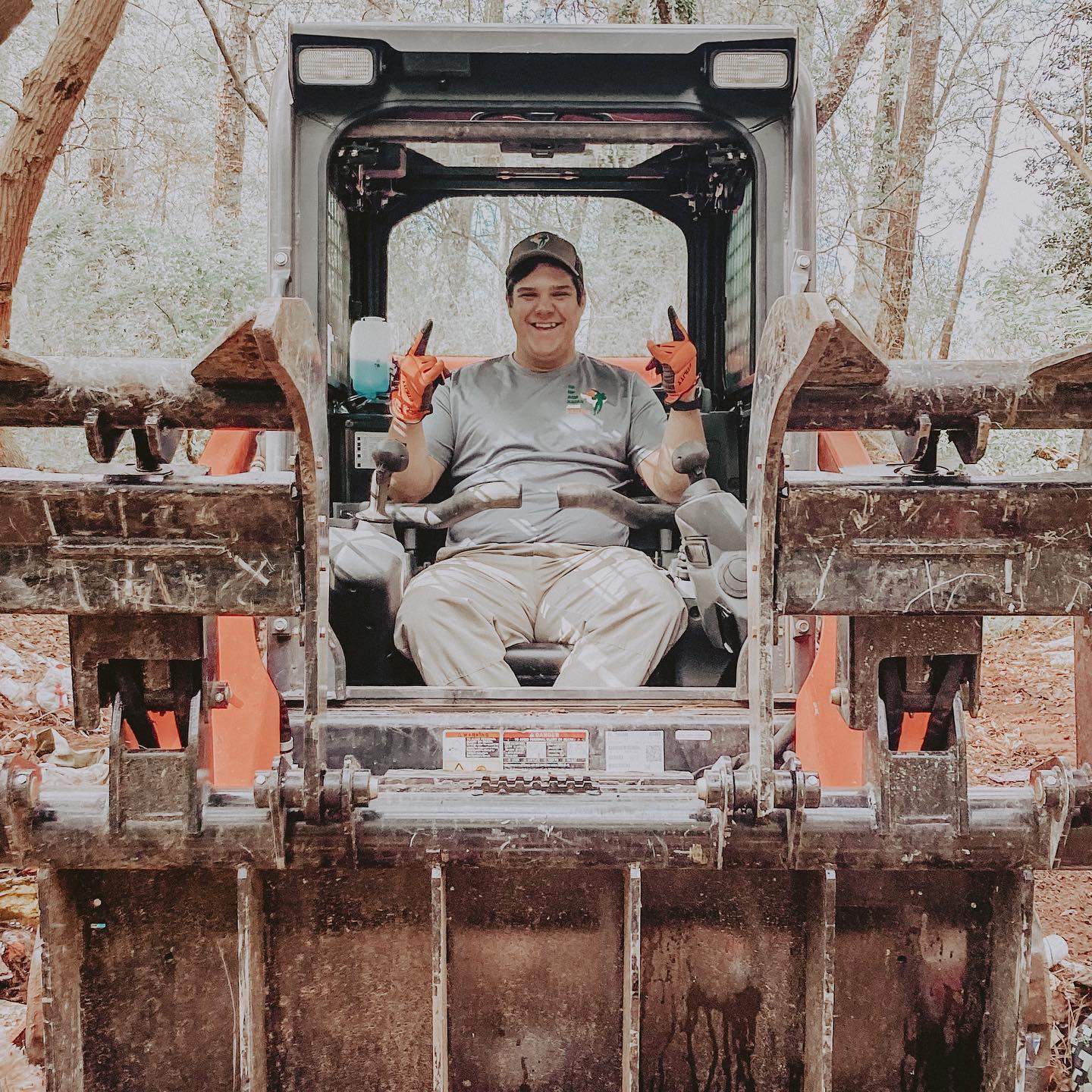 A person sitting on a yard debris removal truck