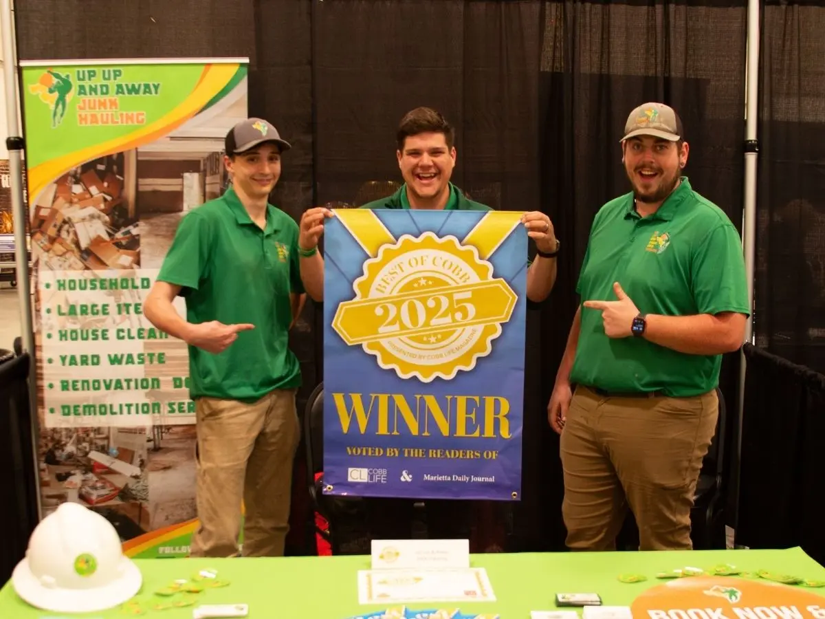 Up Up and Away Junk Hauling Team receiving an award